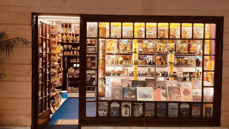 The exterior of a hotel gift shop with glass windows showing books and souvenirs on shelves | HHI Varanasi