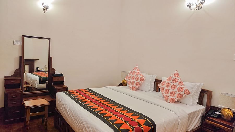 An overview of the Whitehall room with a king size bed, a dressing table along with other amenities - Ibex Stays & Trails, Coonoor (Leewood).