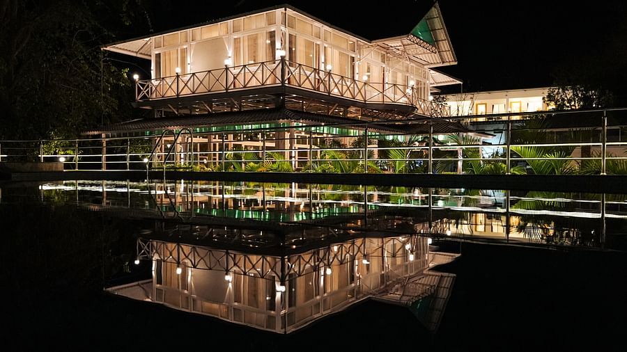 A picture featuring the exterior of the well lit building in the night