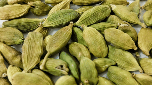 A close up shot of many cardamoms kept together.