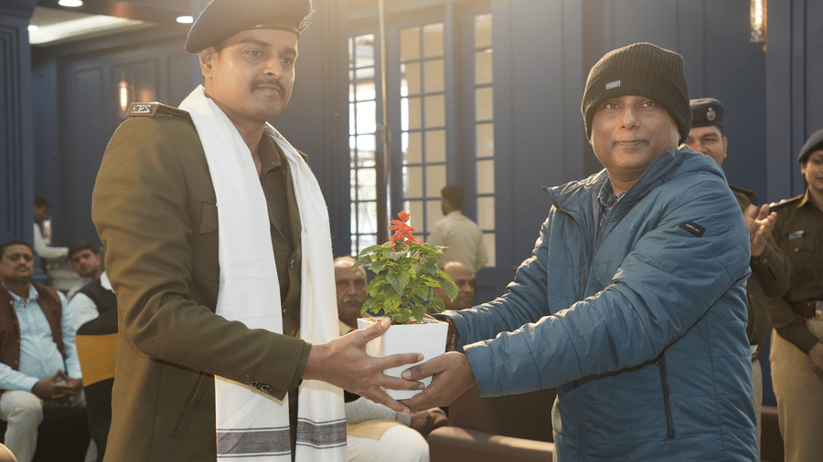 An official receiving a small potted plant as a gesture of appreciation at the Ram Bhawan Ram Yamuna Prasad Hotel and Resort.