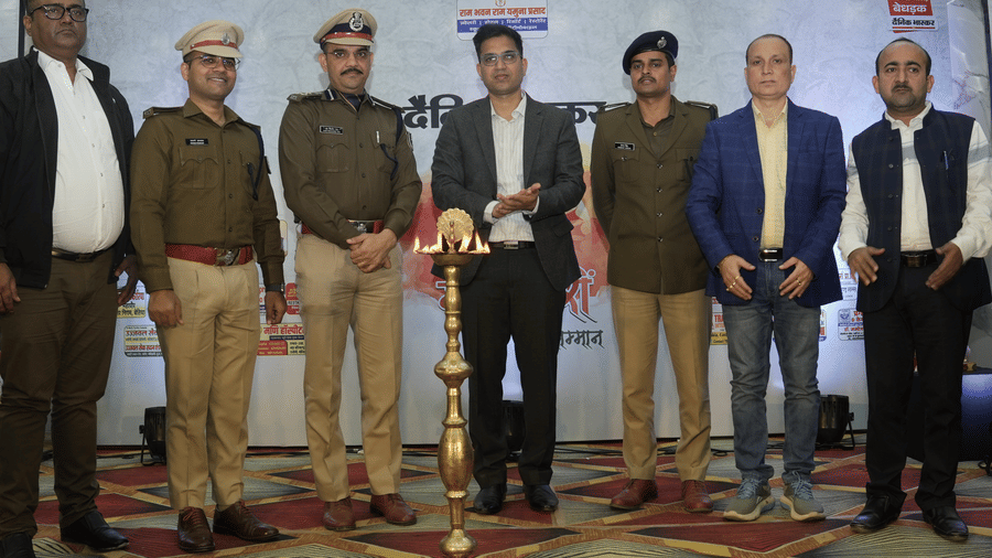 A group of officials standing around a traditional ceremonial lamp at the Ram Bhawan Ram Yamuna Prasad Hotel and Resort.
