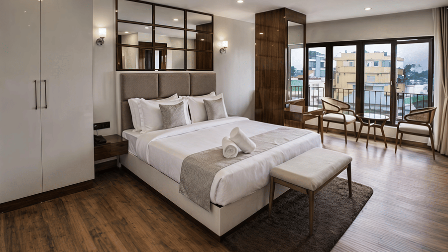 A Premium Room at Valmere Chery Blossom Suites featuring a large bed with a padded headboard, mirrored wall accents, and wooden side panels.