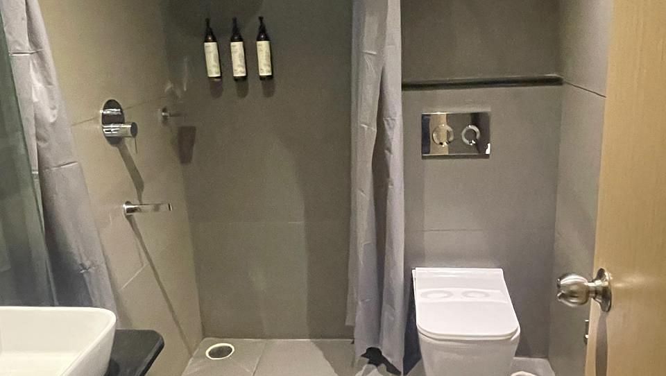 Modern bathroom with glass shower and sleek design at Hotel Kyzen HiTech City – Your Zenly Stay