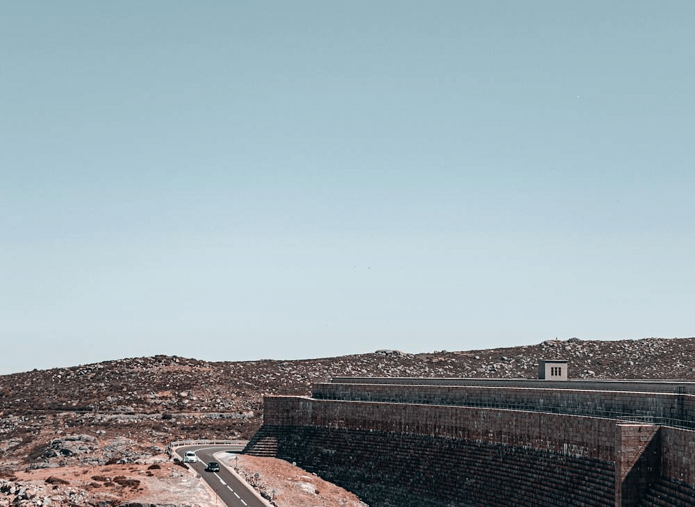 Overhead image of a road surrounded by rocks and empty land.