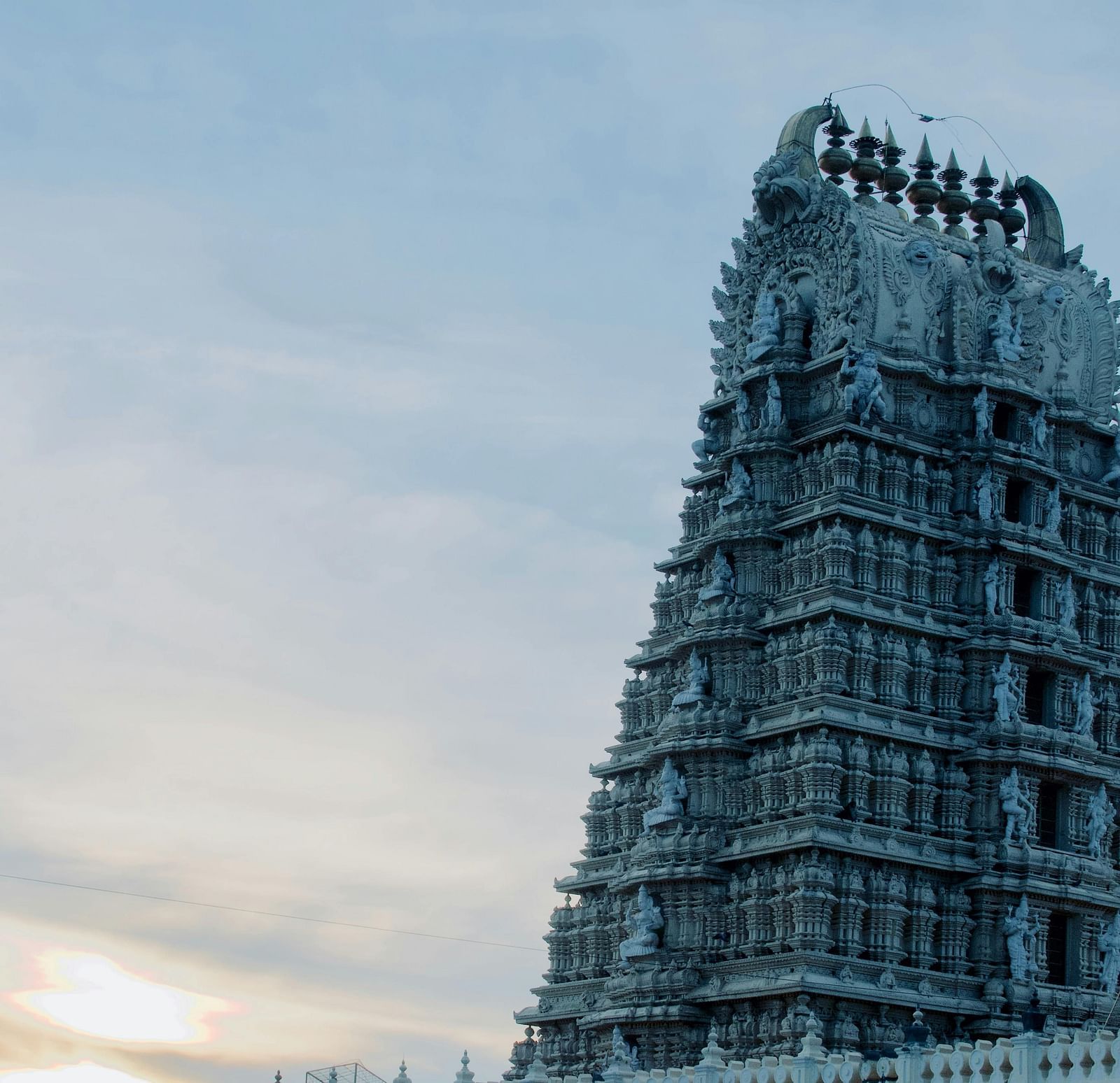 A view from below of a temple's roof with intricate architecture on it.