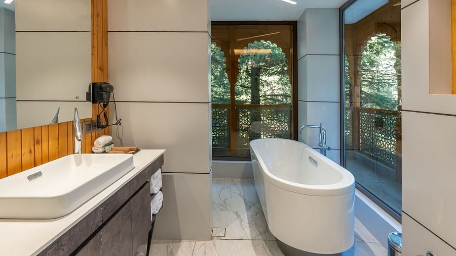 an image of suite bathroom with a bat tub and a wash basin at Mastiff Select Mandavya Dharamkot, McLeodganj