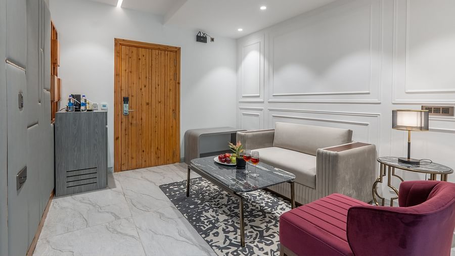 an image of a living area of a suite with sofas and a fruit platter at Mastiff Select Mandavya Dharamkot, McLeodganj