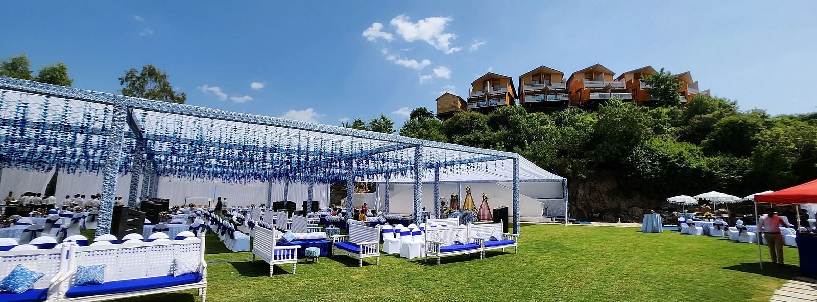 Colourful tents with accents on a lush green lawn.