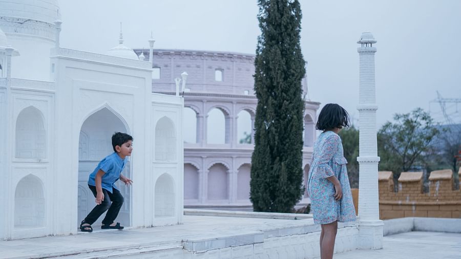 Two kids having fun around the miniature version of the Taj Mahal in the kids play area at Crescent Spa & Resort, Indore