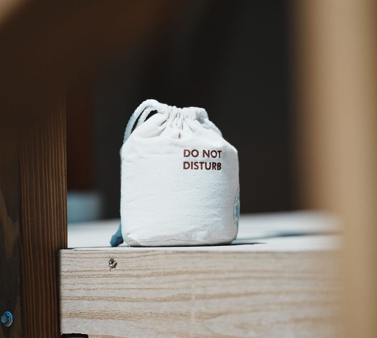 A close-up of a carefully placed amenity setup inside the Peaceful Tent at WoCAL Retreat Ke Ga, including a bag  with do not disturb written on it on a clean wooden counter, reflecting thoughtful hospitality.