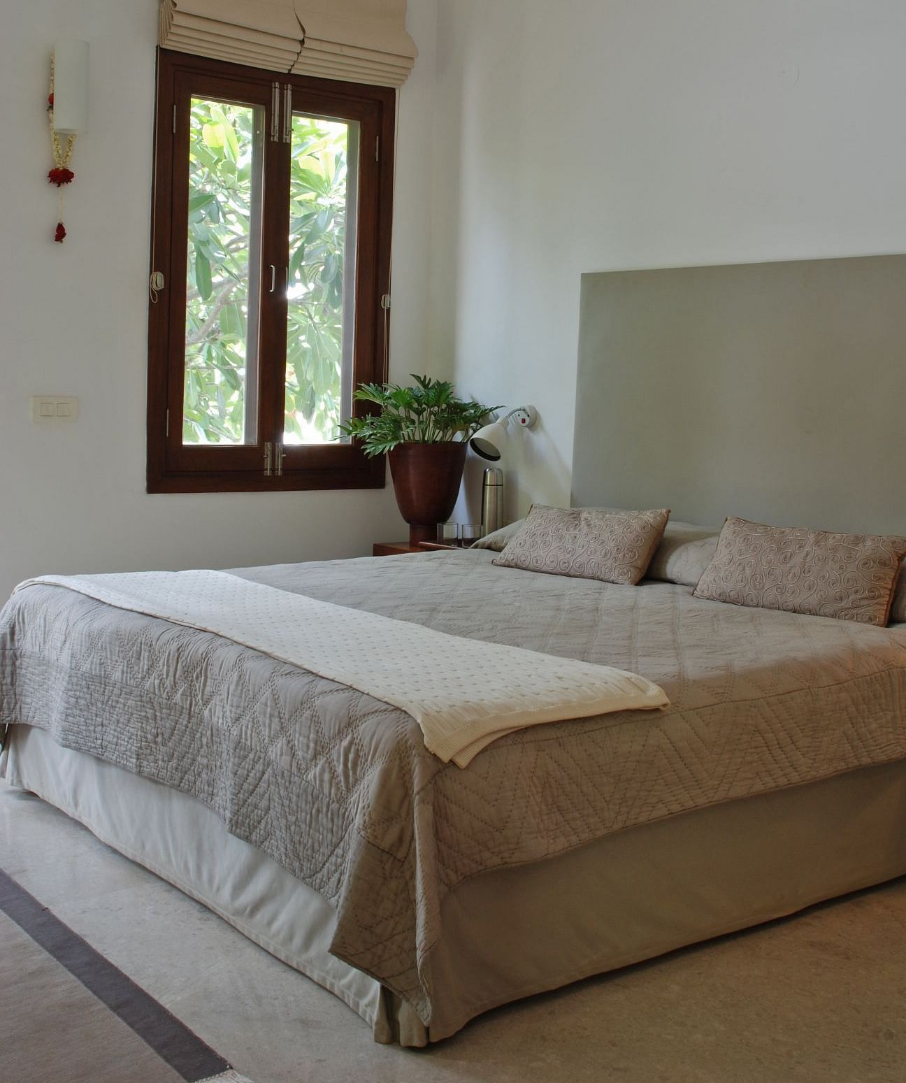 A cosy bedroom with neutral tones and a comfortable bed - Shreyas Retreat