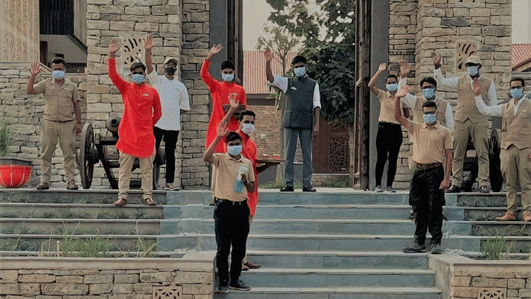 Aramness staff waving at the entrance gate