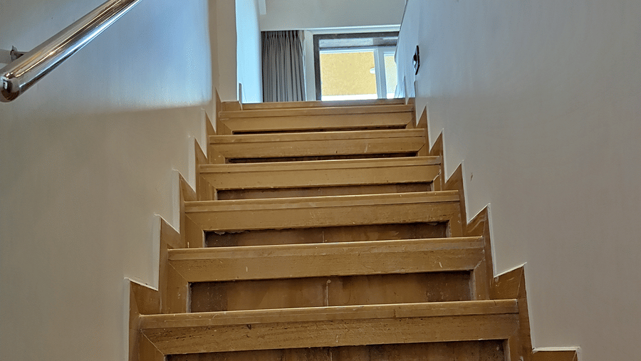 Wooden staircase leading to an upper level