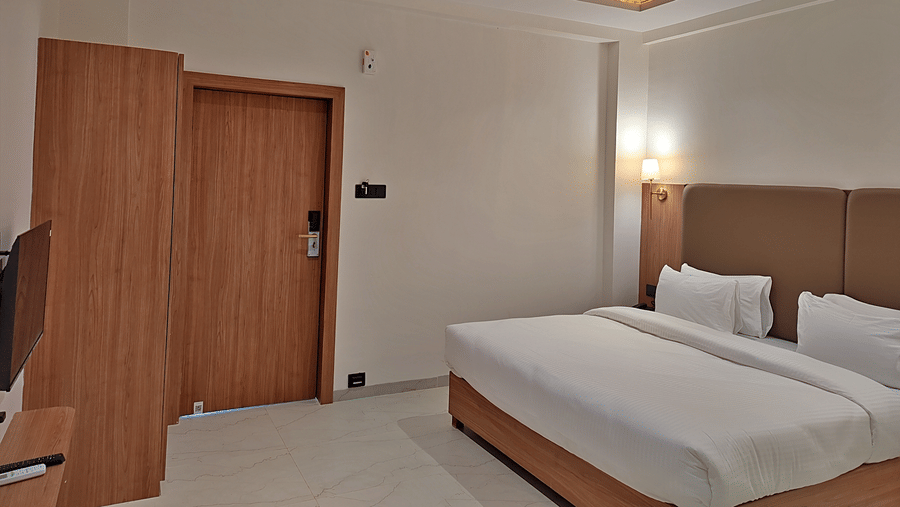 side view of a bedroom with wooden interiors and bright lights.