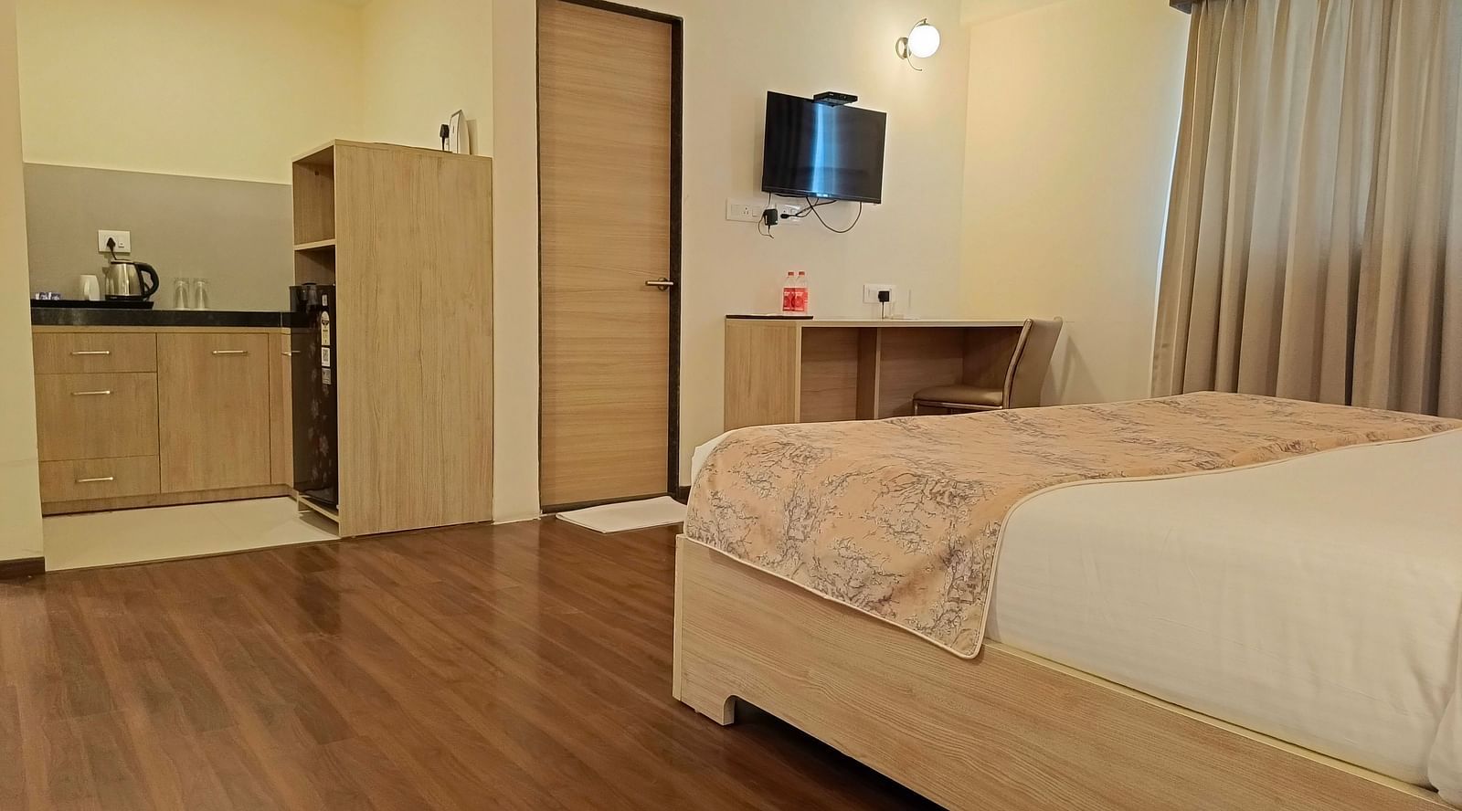 View of the small kitchenette including a fridge inside Premium Studio at Starlit Suites, Shirdi