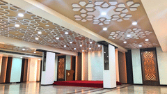 an empty Banquet Hall in Tirupati with many lights switched on - Raj Park Hotel, Tirupati