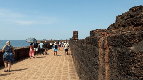 Visitors walk along the historic Fort Aguada in North Goa.