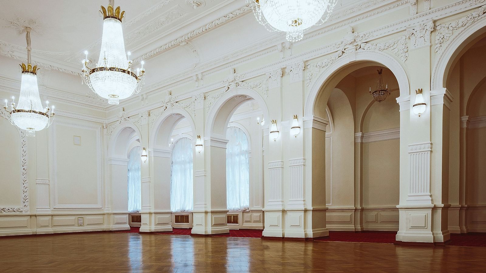 Banquet Hall with white walls and chandeliers