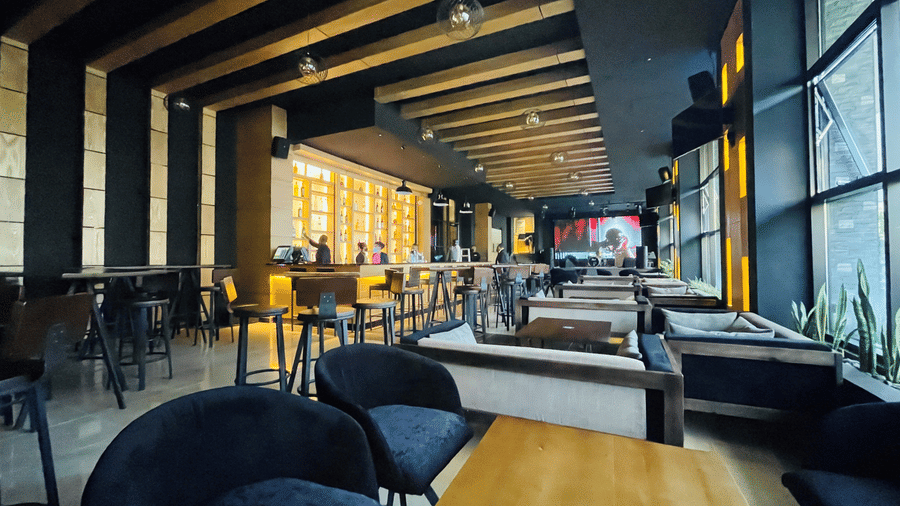 An overview of the seating arrangement inside Oak Lounge with lighting in view inside Ramada by Wyndham Addis, Addis Ababa
