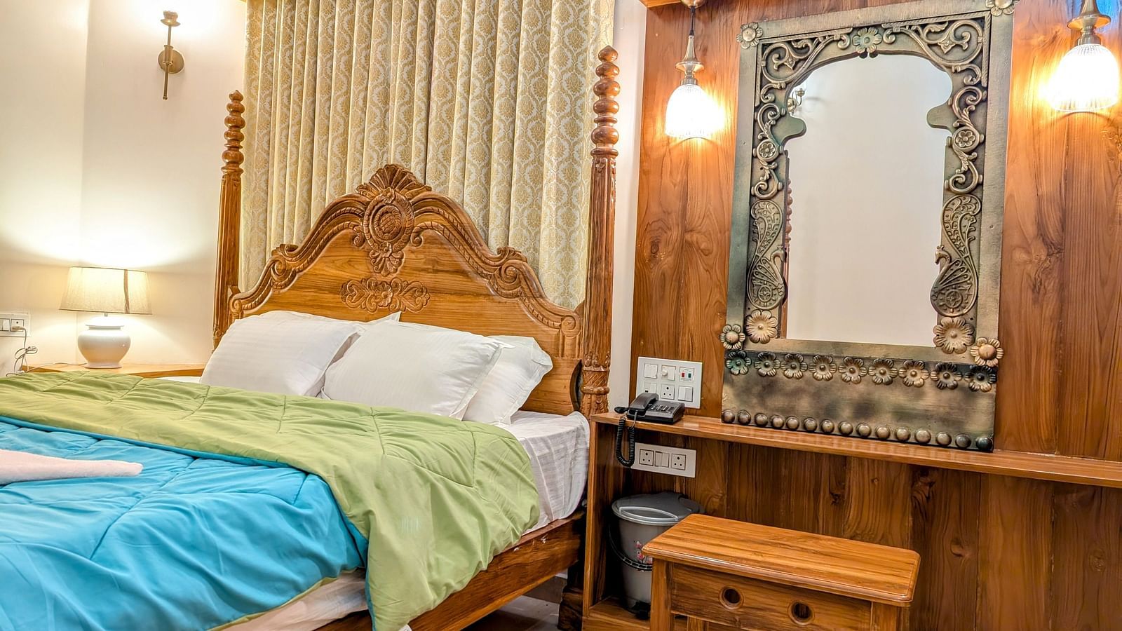 image of a double bed at the pool side cottage at dip holidays along with a dressing table besides it