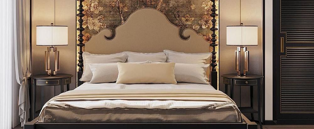 Front view of a well-made bed with cushions, a ceiling fan, and two bedside tables with lamps at The Evren, Vagator.