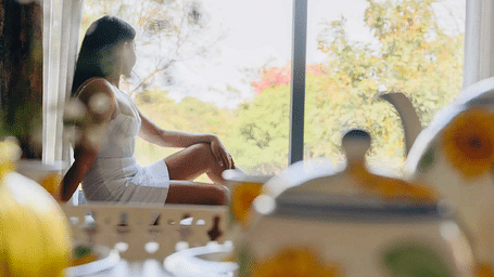 Women sitting on a window sill with teapots at Karma Chalets.