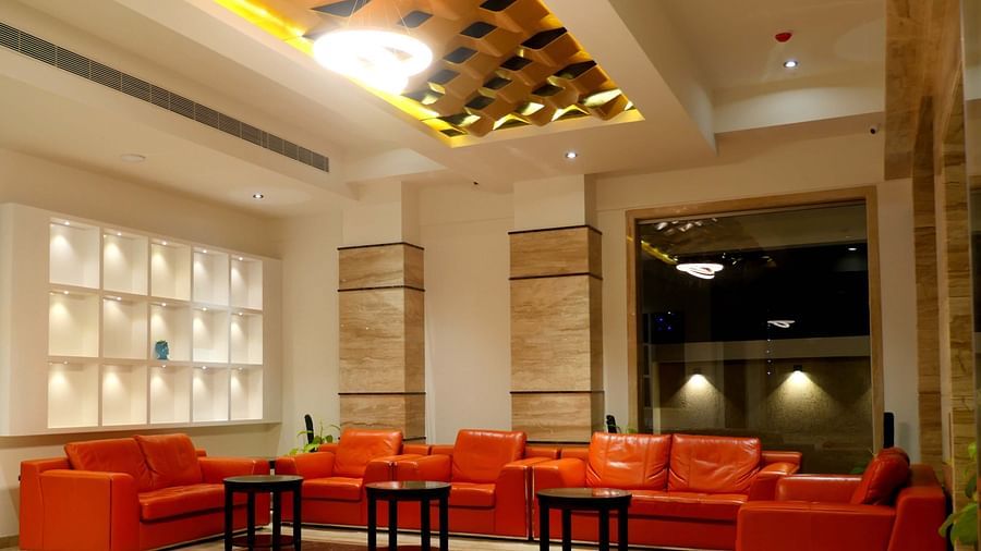 lobby with comfortable chairs and warm lightining of ASR Parklane, Hosur
