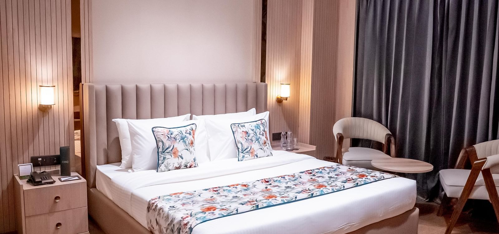 Executive Suite with a bed, bed side tables, chairs and a window with a curtain in the background at ASTER GRAND BY ZENQ SAKET.