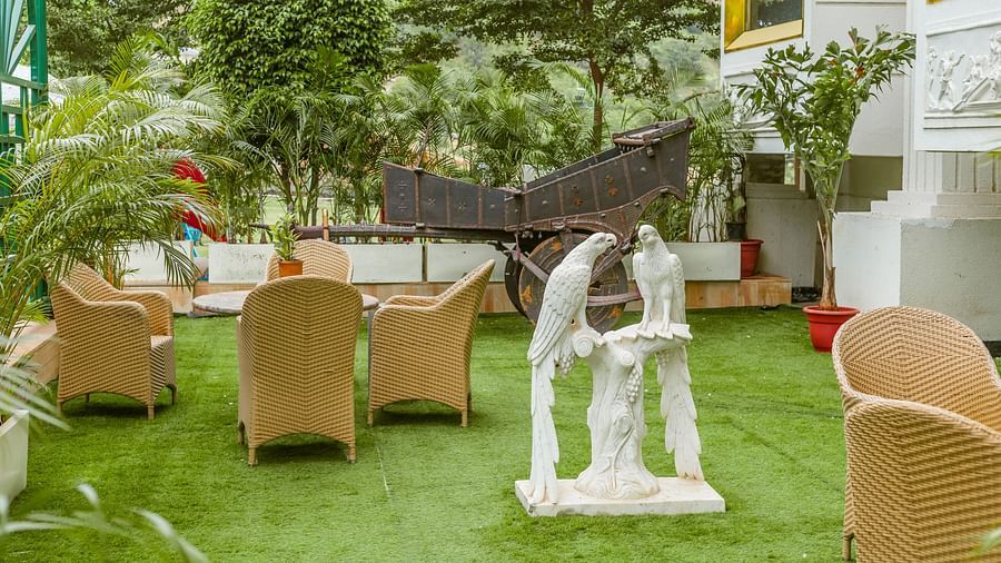 An image of a rooftop lawn with a coffee table and chairs arranged for sitting and relaxing