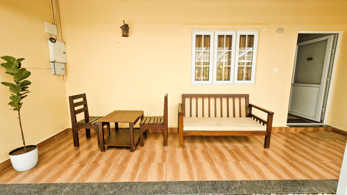 Outdoor seating area with seating arrangement at Ibex Resorts, the best resort in Valparai.
