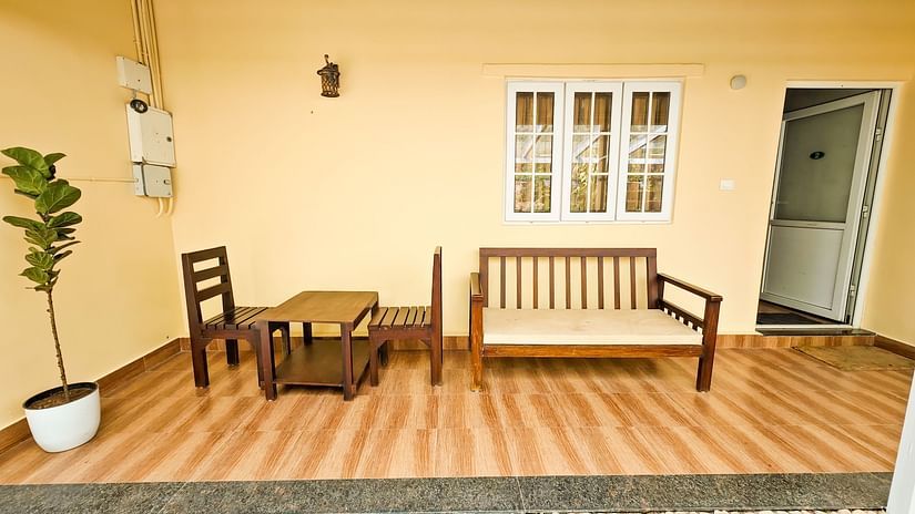 an image of an outdoor seating area with seating arrangement at Ibex Stays & Trails, Valparai (Mistly).