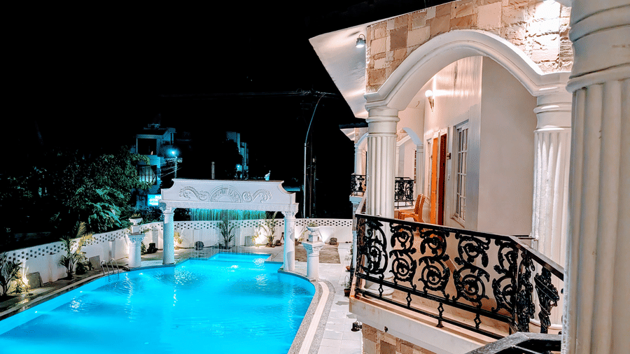 Elevated view of the swimming pool in the night taken from a higher floor at Dip Holidays.