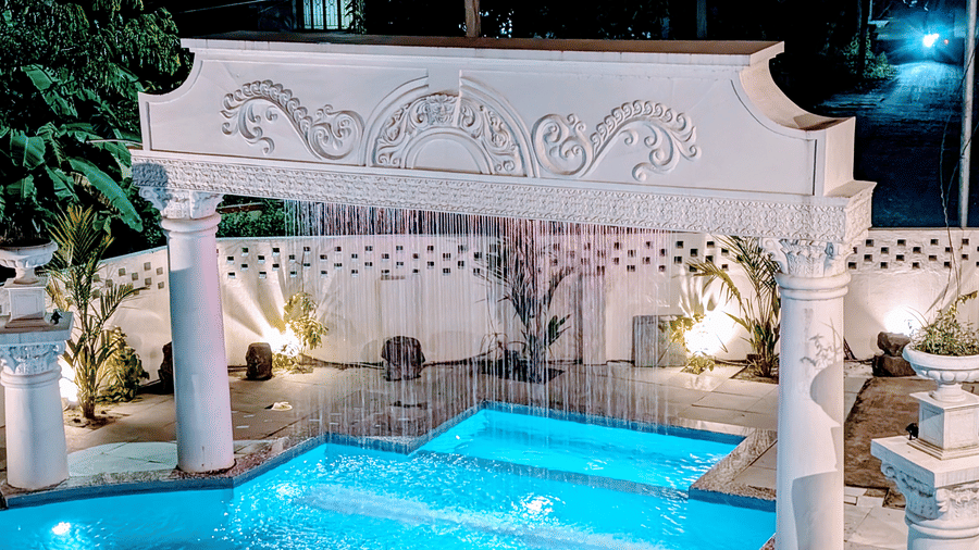 A beautiful fountain seen at night over the outdoor swimming pool at Dip Holidays.
