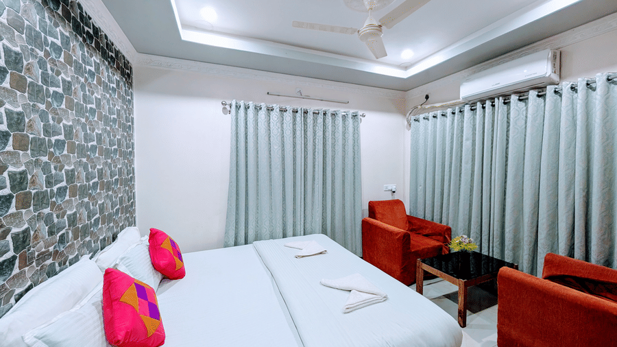 Deluxe room with a king-size bed, elegant décor, and comfortable seating.