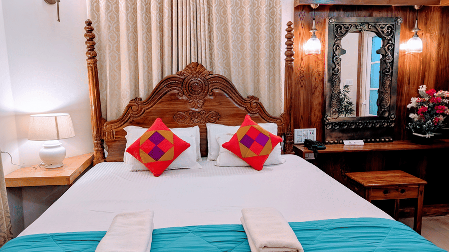 The pool side cottage featuring a double bed with a elegant headboard in the back