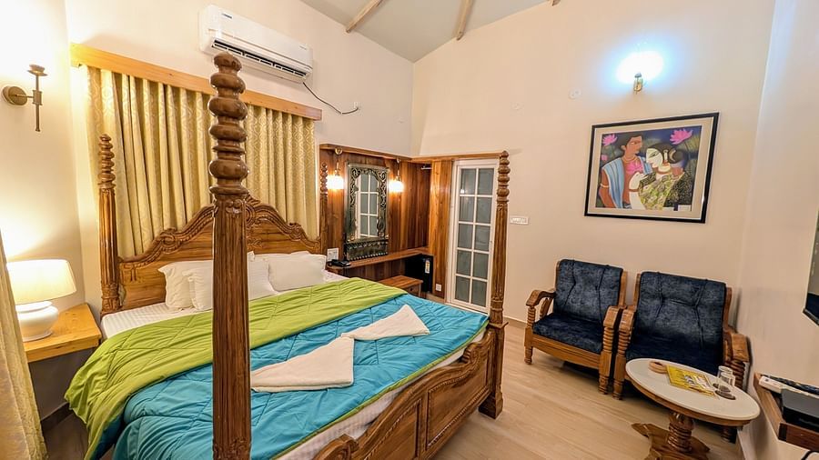 full view image of the pool side cottage featuring a double bed along with cushioned couch in the corner at dip holidays