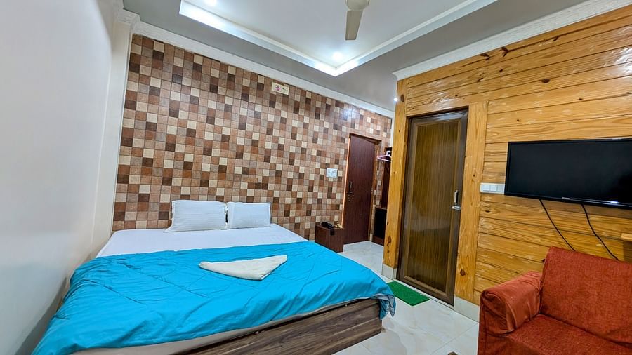 image of a standad room at dip holidays featuring a double bed with sky blue coloured sheet spread over it