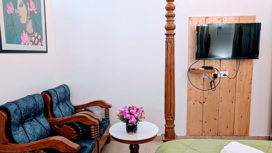 image featuring a cushioned couch along with a wall mounted television in the pool side cottage at dip holidays