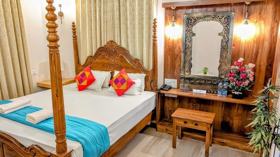 A double bed at the pool side cottage at dip holidays along with a dressing table besides it