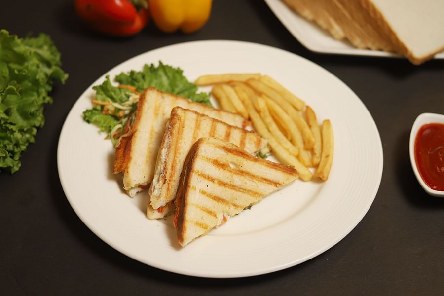An image of sandwiches served with french fries at a restaurant in Five Elements Hotels North Avenue, Delhi