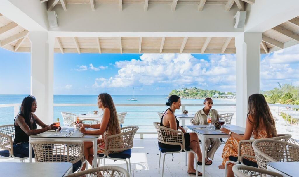 Friends enjoy drinks by the sea under a shaded terrace, with stunning ocean views and a peaceful Caribbean breeze - Tamarind Hills Resort and Villas - Antigua