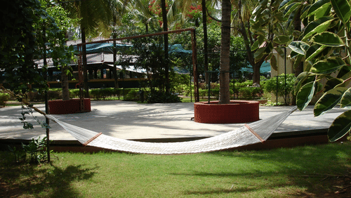 Image of lawn featuring hammock and green surroundings at Fantasy Golf Resort Bangalore