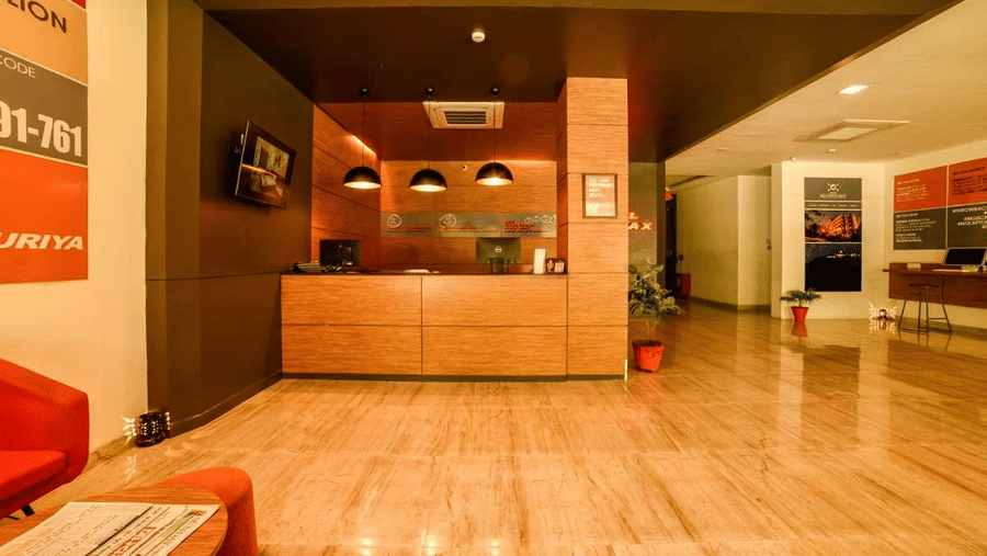 An image of a reception lobby featuring a reception desk , and a seating area for the guest - Max Hotel Jabalpur