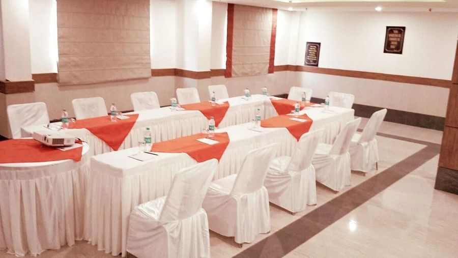 tables and chairs setup in the darbar hall in a boardroom setting - Max Hotel, Jabalpur