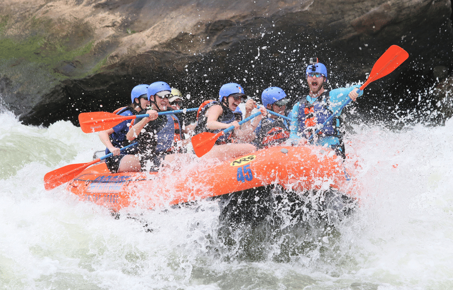 An exhilarating whitewater rafting adventure on a turbulent river with a group of six in an inflatable raft.