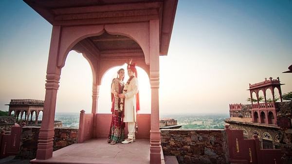 A bride and a bridegroom posing for a picture