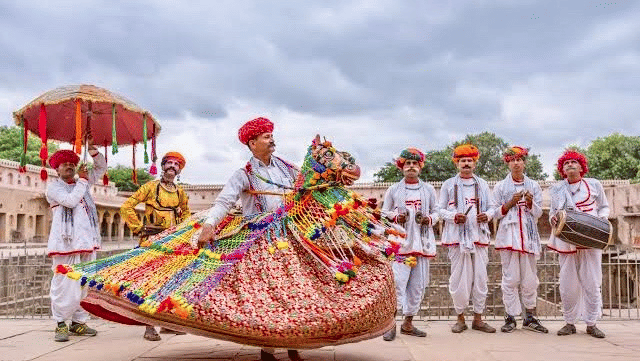 Traditional Rajasthani folk dancers performing at a wedding celebration at Umaid Palace.