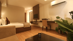 A cozy and modern hotel room with a comfortable sofa and a work desk - Marigold Sarovar Portico, Mashobra-Shimla