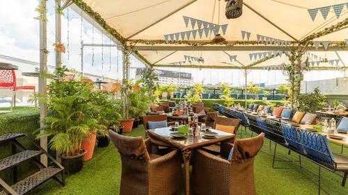 Green-themed terrace seating at Fox In The Field restaurant